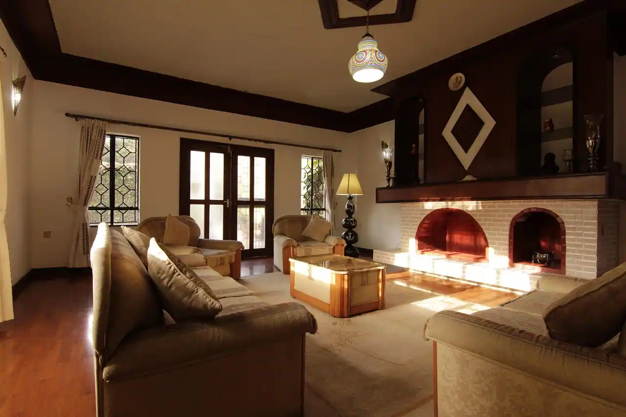 A panoramic view of the Vista Valley hotel nestled in a lush, green valley at sunset.